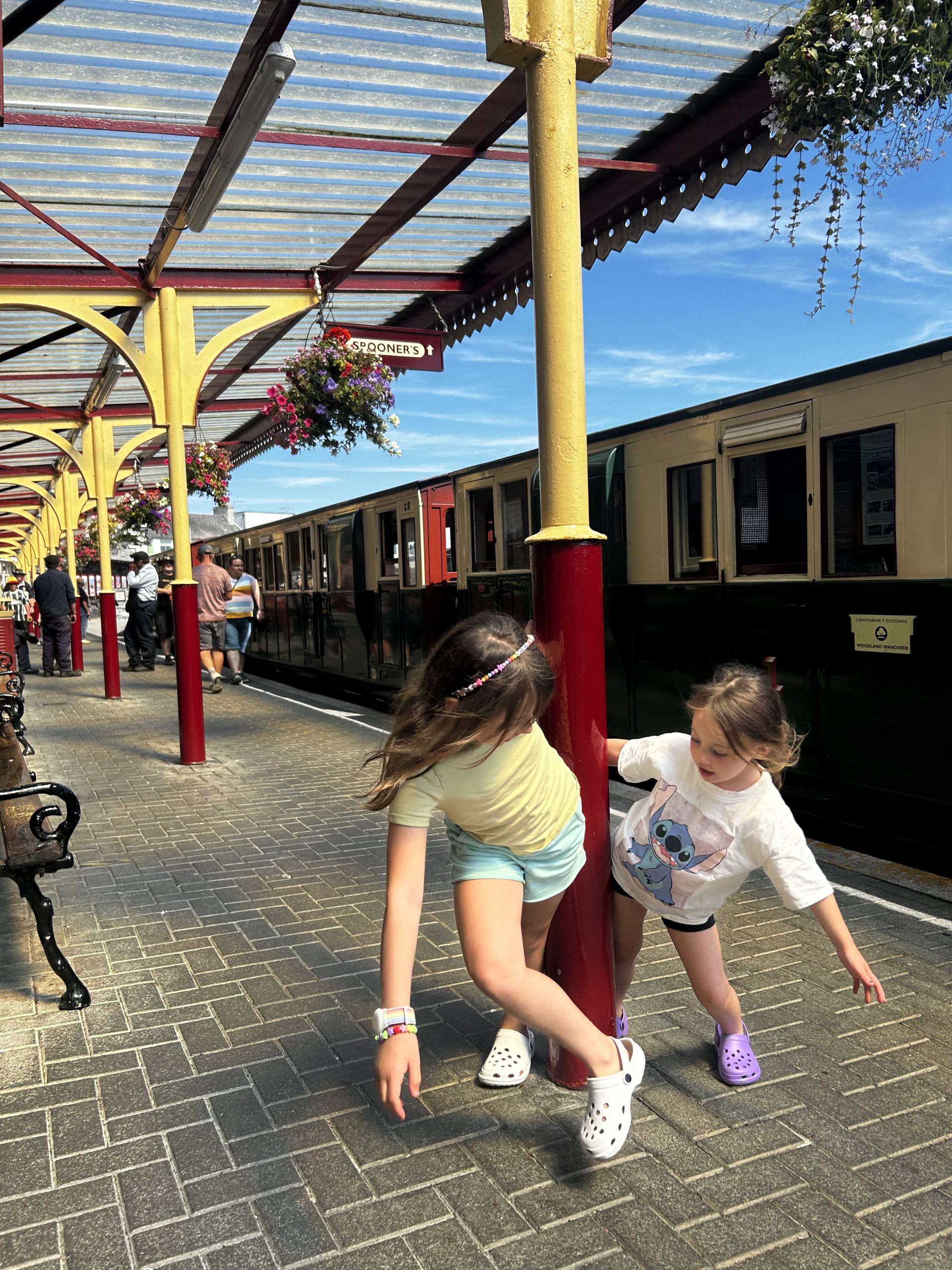 Two girls play at Porthmadog Train Station