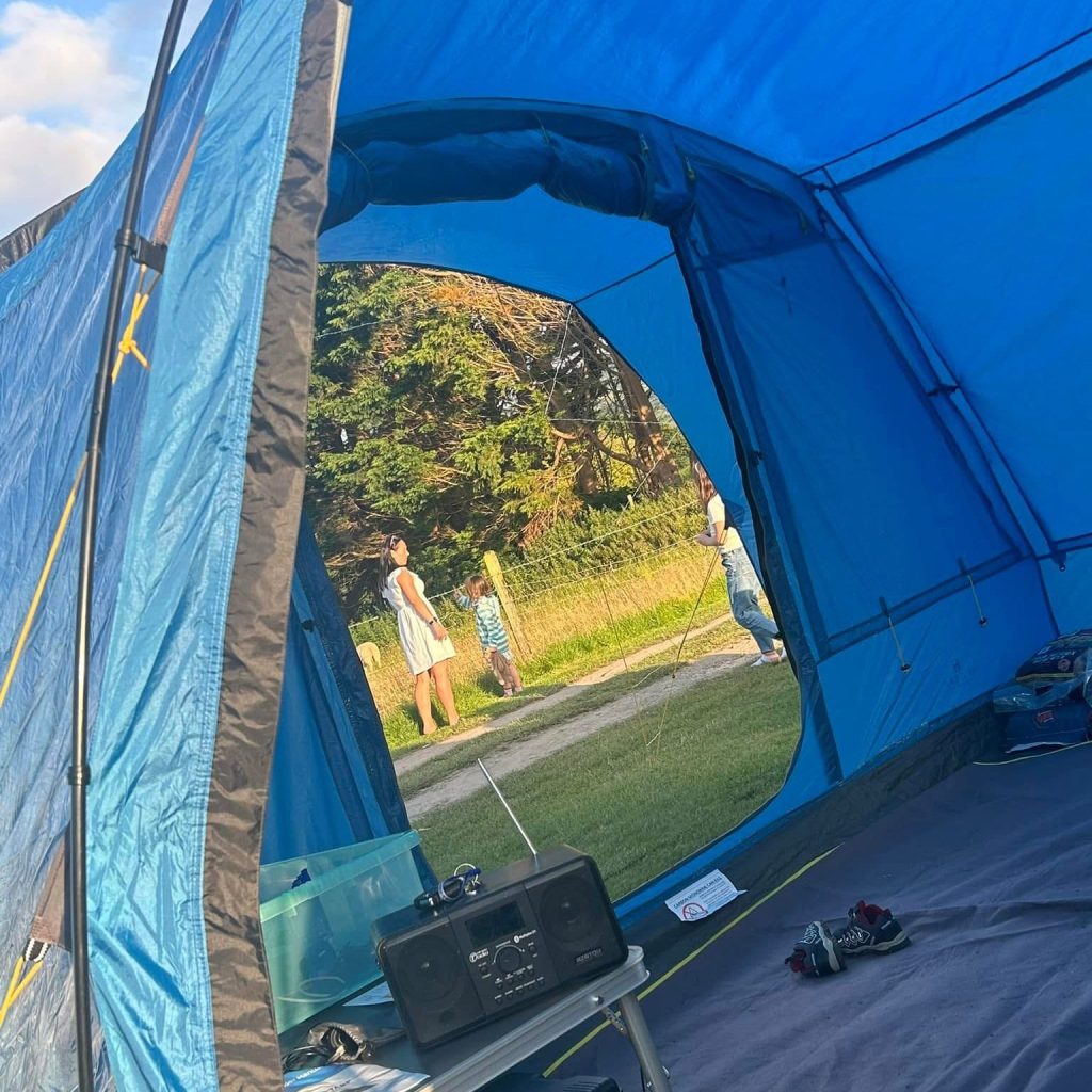 Mother and Daughters Outside a Tent in the UK