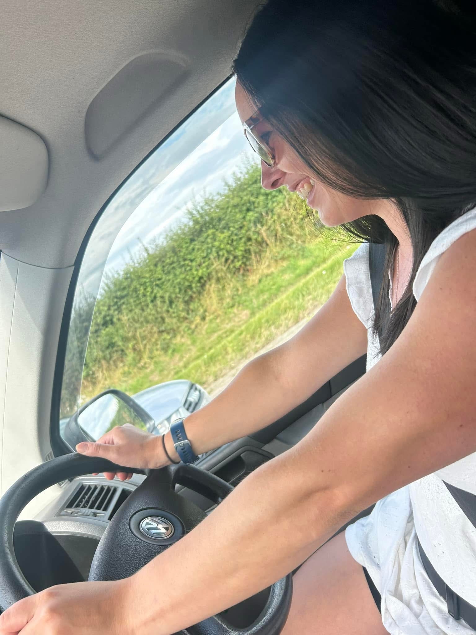 A Mother drives the campervan on a family camping trip