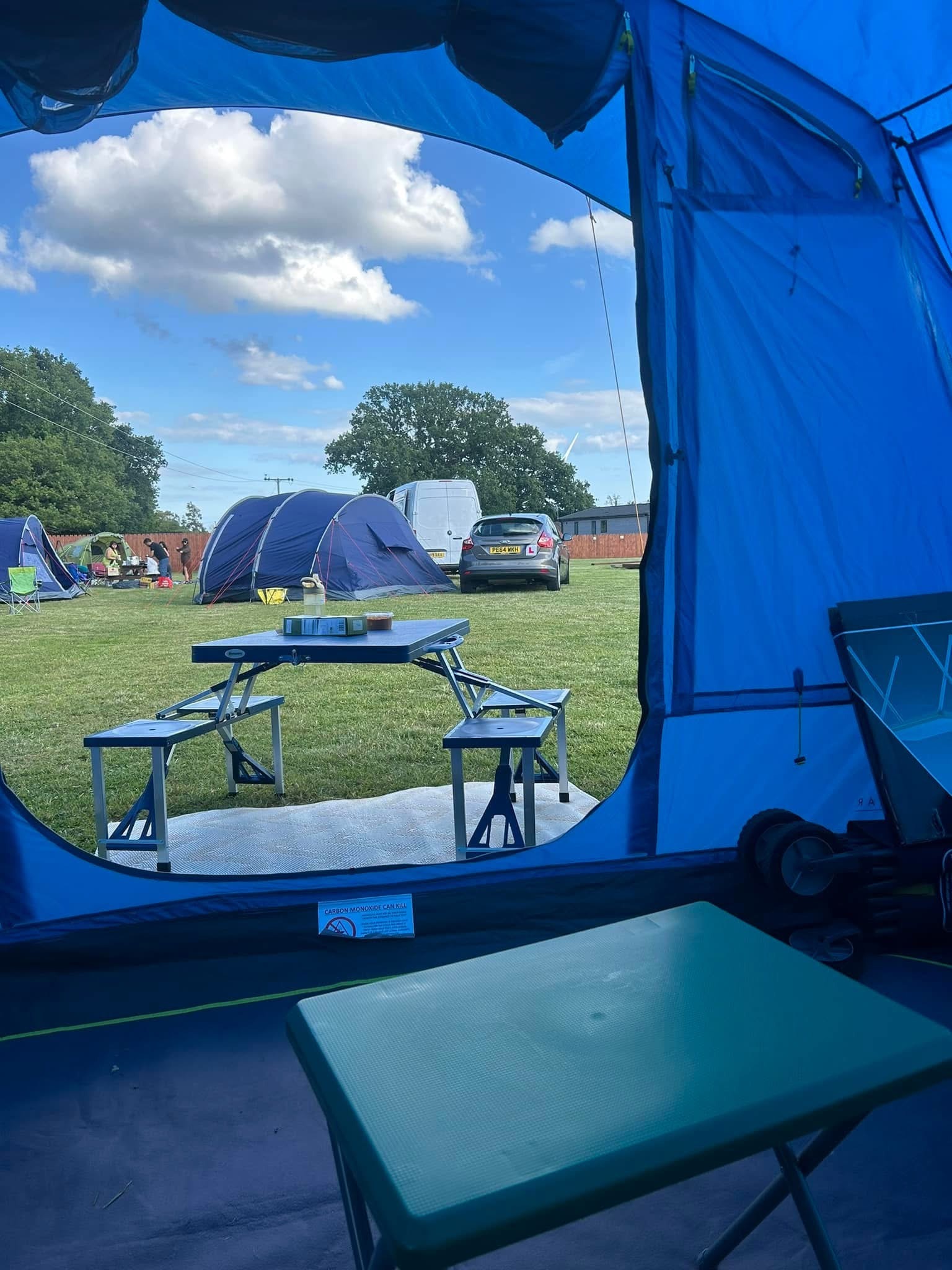 A VW Campervan next to a tent and a glamping tent