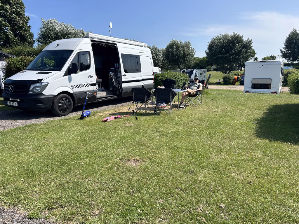 A Campervan set up on a pitch at Waldergraves holiday park on Mersea Island in Essex UK