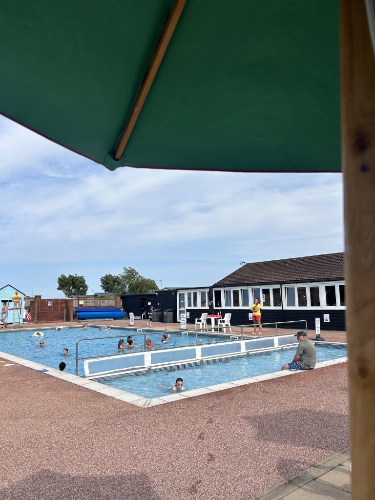Families swimming in the pool at Waldergraves Holiday Park in the UK