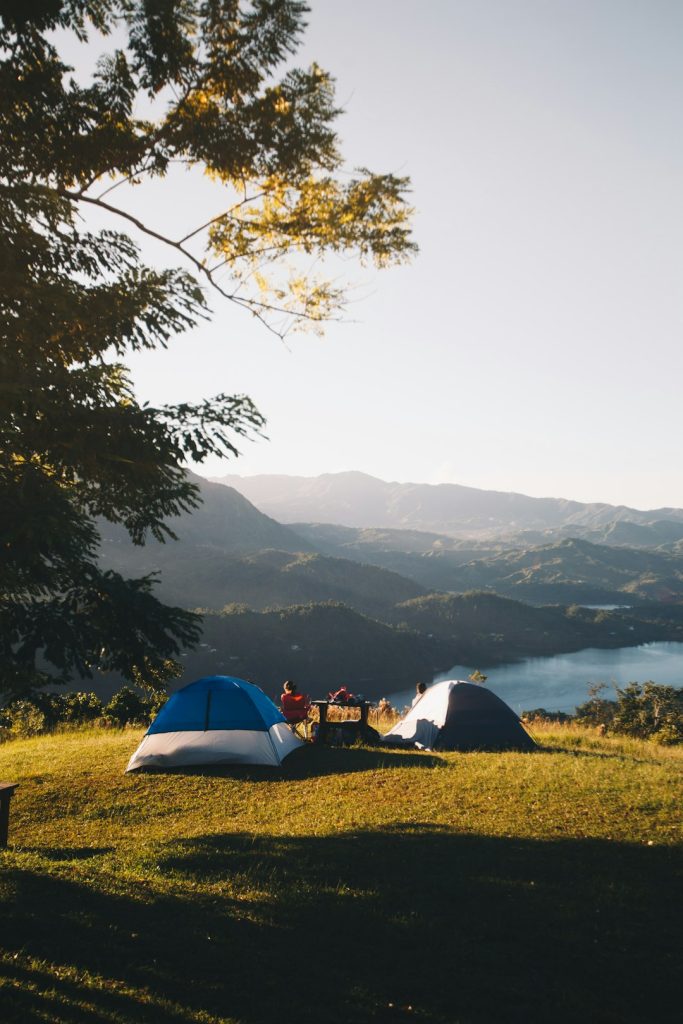 Two tents on a mountainside campsite